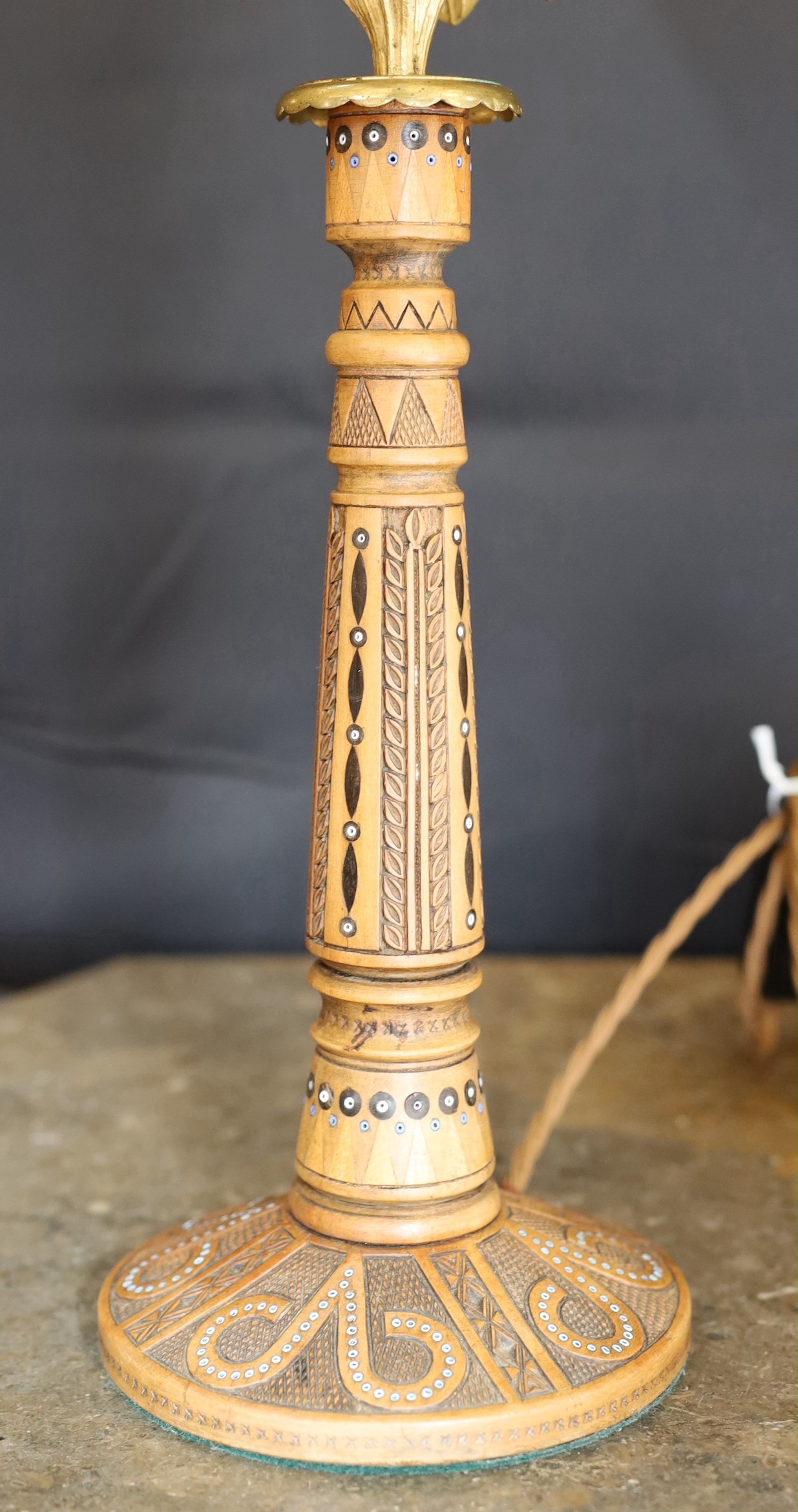 An early 20th century Danish carved and glass bead inset wood lamp base with brass flowerhead mount and associated tinted and frosted glass shade, height to top of shade 47cm